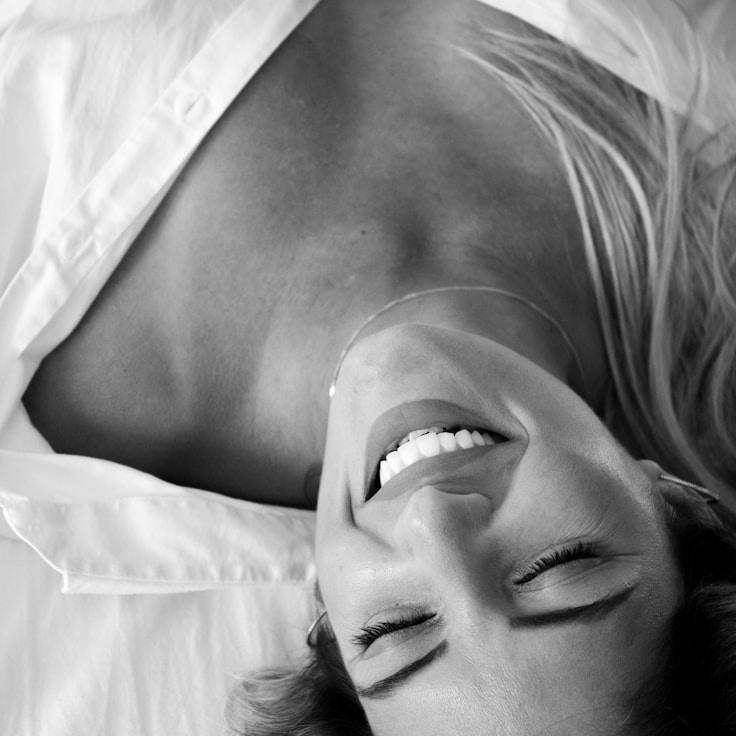 Avery Chen, Lead Design Curator at Meadow Orchard Sun, reviewing corporate floral arrangements